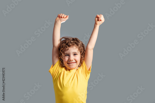 Portrait of funny girl laughing holding hands up