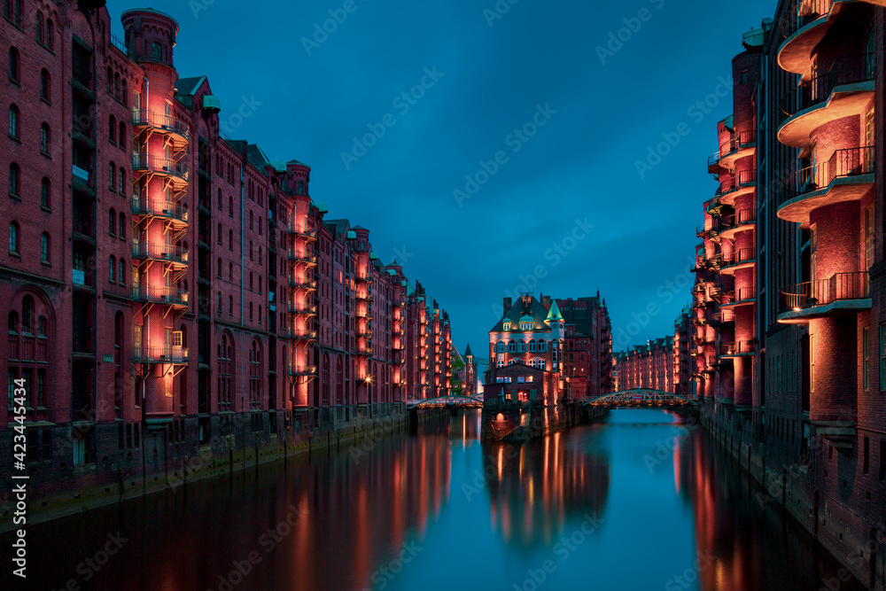 Fototapeta premium View of the Speicherstadt at night.in Hamburg, Germany..Illuminated Speicherstadt as seen from the Poggenmühlenbrücke.