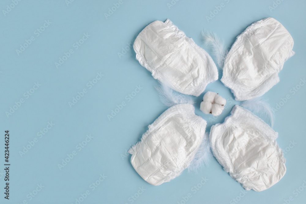 Baby diaper on a blue background. with copy space. Hygiene and child care. Soft comfortable cotton panties. top view. lat lay Baby diaper on a blue background. with copy space. Hygiene and child care. Soft comfortable cotton panties. top view. lat lay