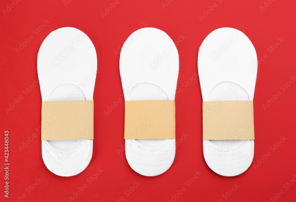 White cotton socks on red background, flat lay White cotton socks on red background, flat lay