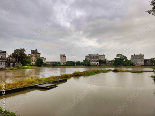 Kaiping diaolou and villages. Сoncrete watchtowers. Houses and flooded rice fields. Cloudy weather. China. Asia 