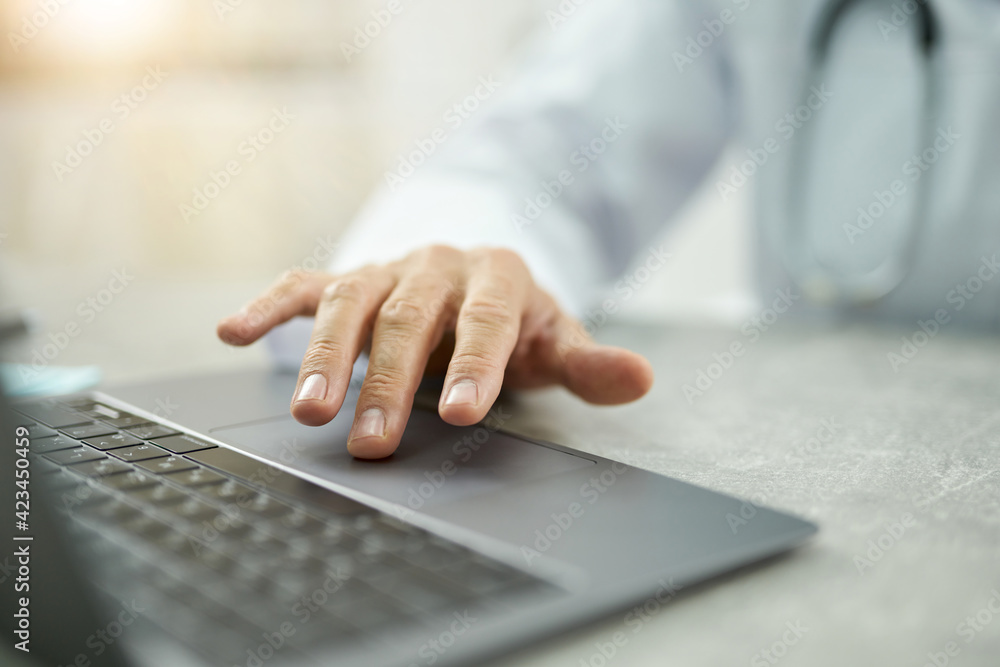 Male doctor hand using modern laptop in clinic Male doctor hand using modern laptop in clinic
