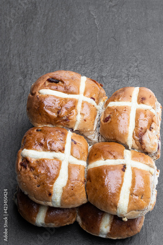 Easter wholemeal hot cross buns on black stone backgrond photo