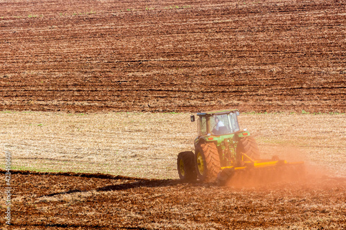 Принти на полотні Tractor plowing land to plant sugar cane