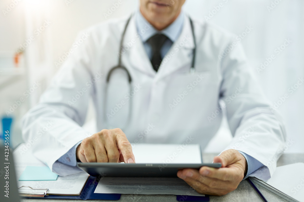 Male doctor using tablet computer at work Male doctor using tablet computer at work