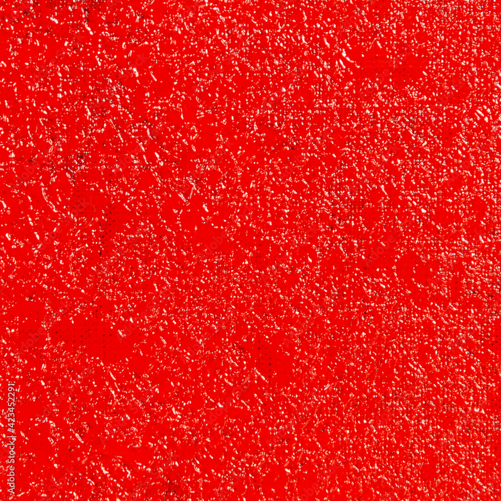 abstract creative background: red stain of colored primer when toning the canvas, temporary object.
