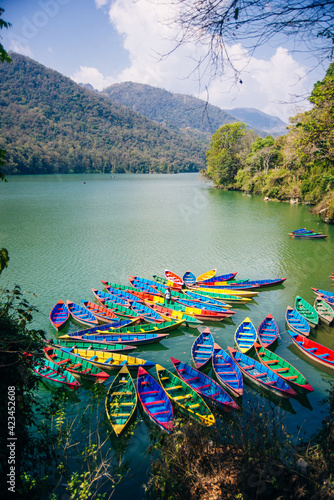 Phewa Lake with multicoloured boats in the valley of Pokhara in central Nepal. photo