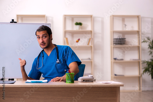 Young male doctor in front of whiteboard