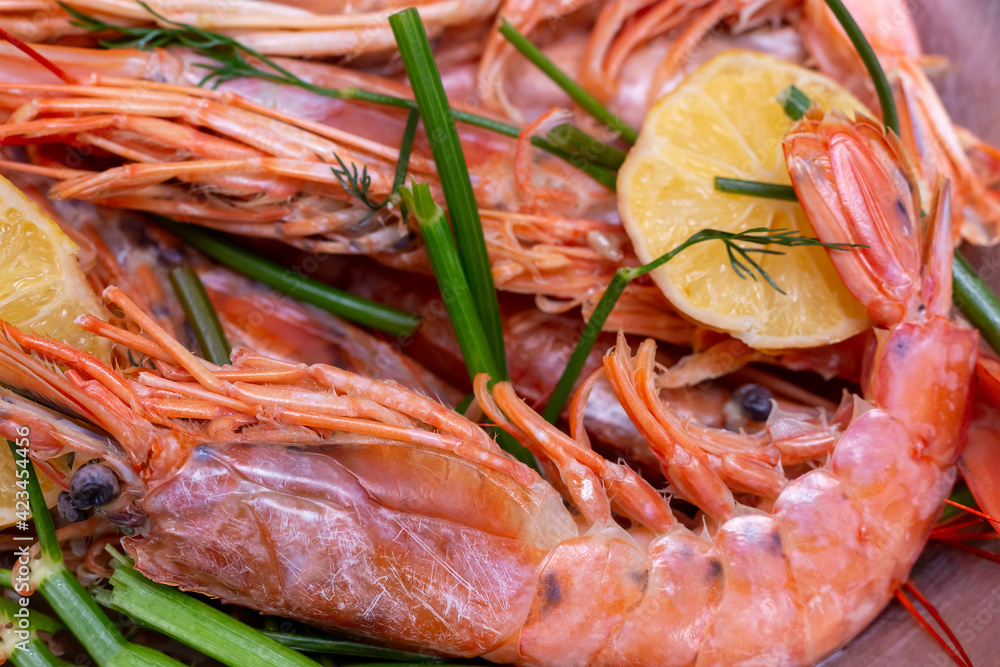 fresh and tasty prawns with lemon and dill in a bowl