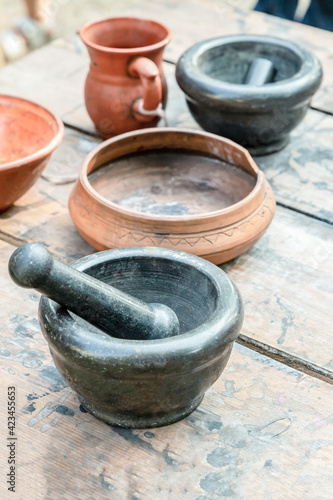 set of dishes mug mortar and pestle black and clay plate on the table vertically © Kai Beercrafter