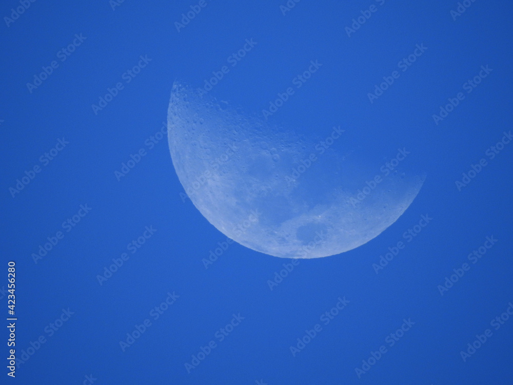 Half of the moon on a blue background Half of the moon on a blue background