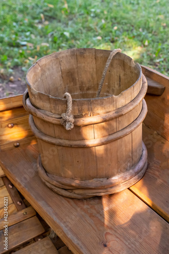 traditional wooden water bucket stands on the table