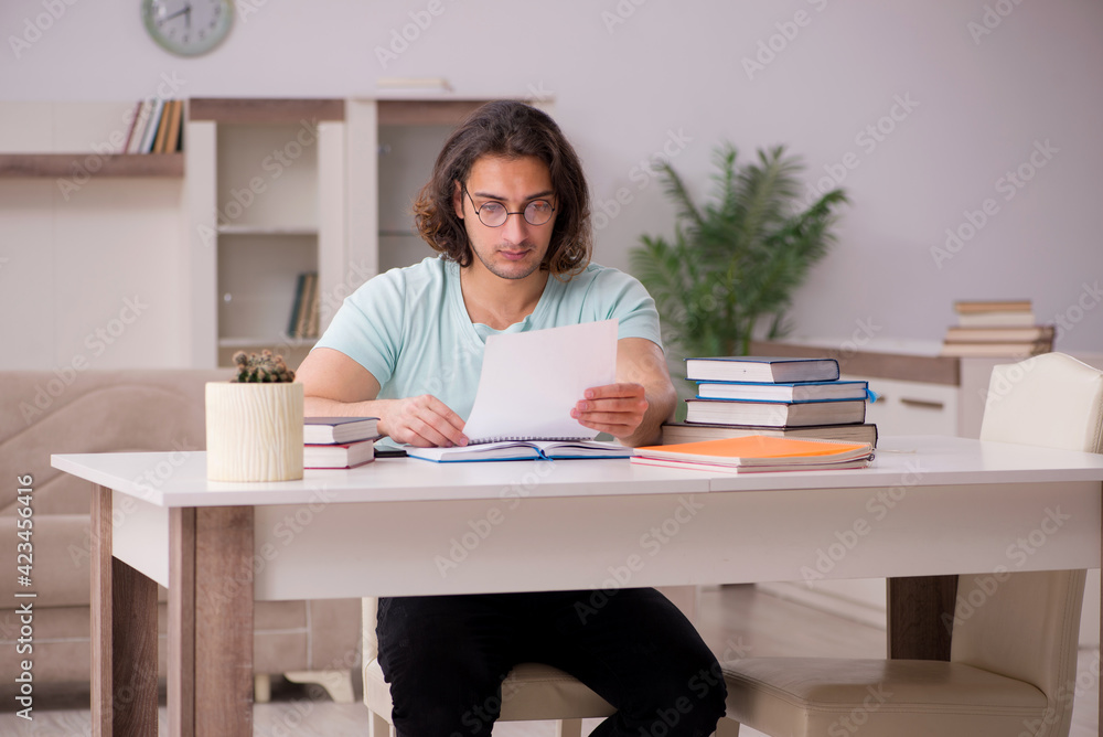 Young male student preparing for exams at home Young male student preparing for exams at home