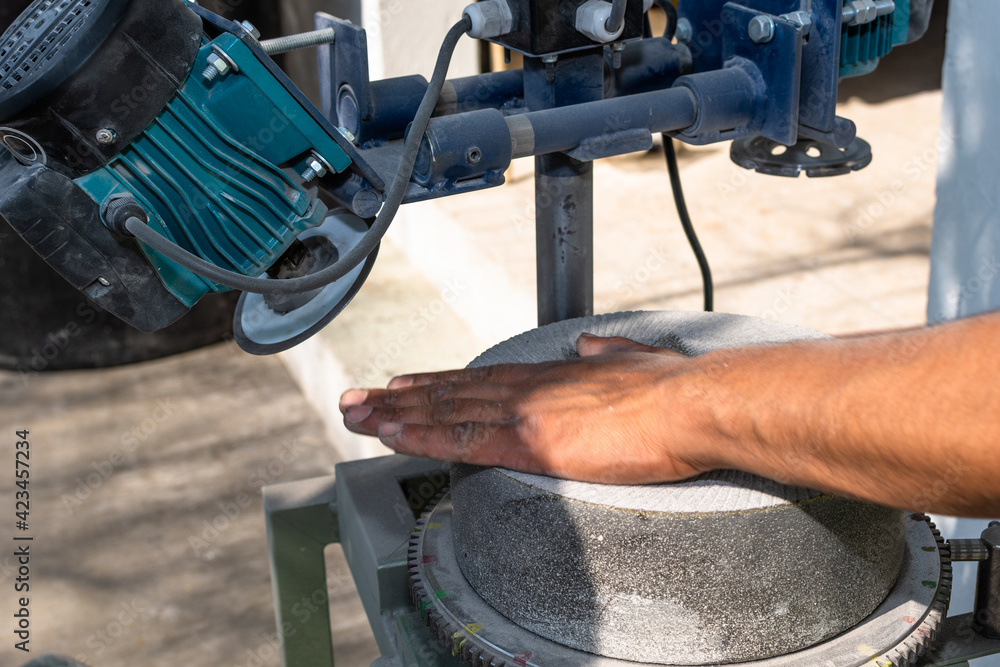 stones used to grind corn being rectified with a special machine for this