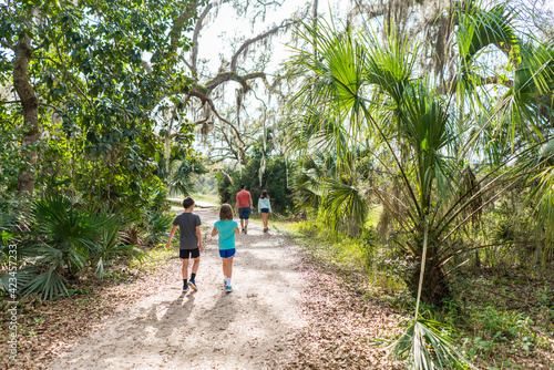 Family hiking outdoors on a path in Florida