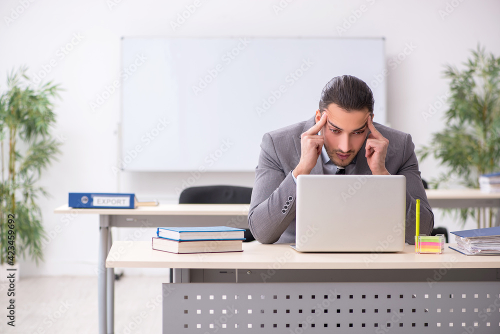 Young male employee working in the office Young male employee working in the office