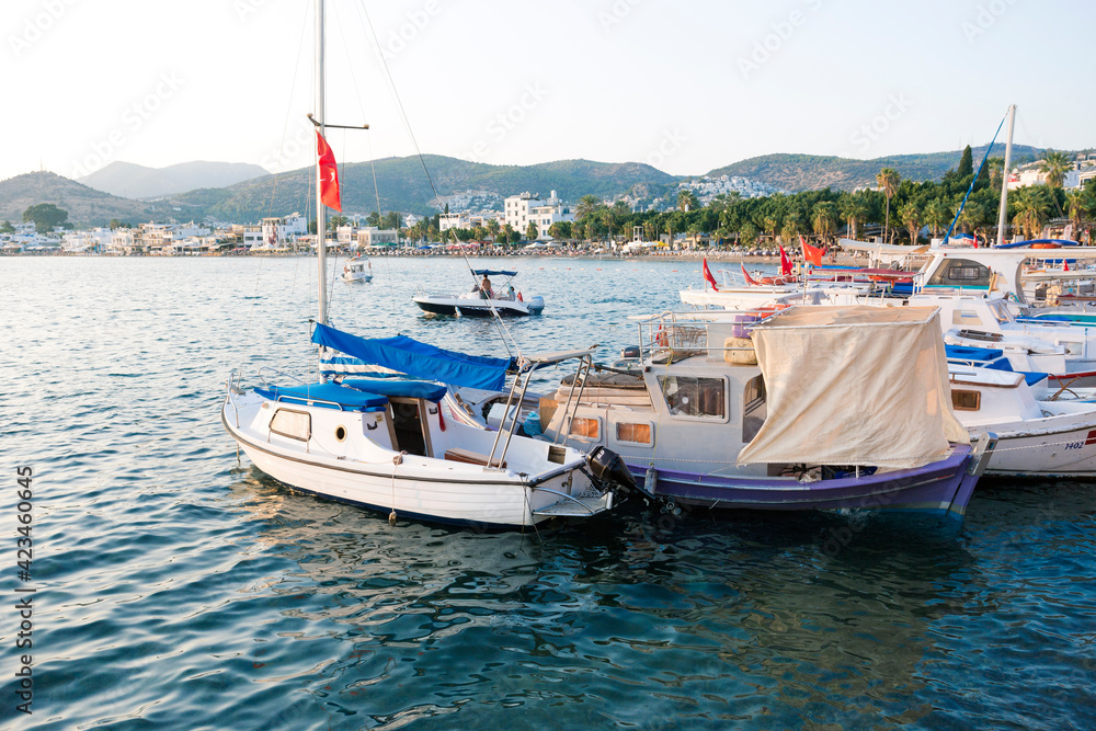 Beautiful View of Bodrum Beach, Aegean sea, yacht and town at sunset.