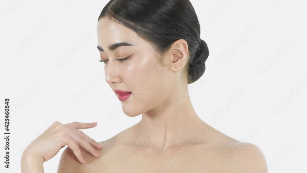 Beauty concept of 4k Resolution. A young Asian woman caresses her skin on a white background. Beauty concept of 4k Resolution. A young Asian woman caresses her skin on a white background.