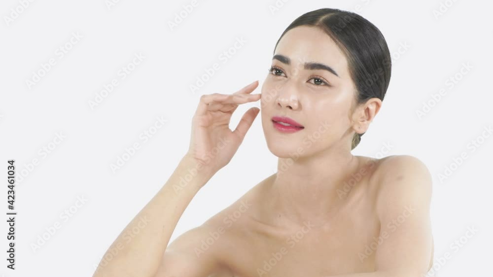 Beauty concept of 4k Resolution. A girl caressing her face on a white background. Beauty concept of 4k Resolution. A girl caressing her face on a white background.