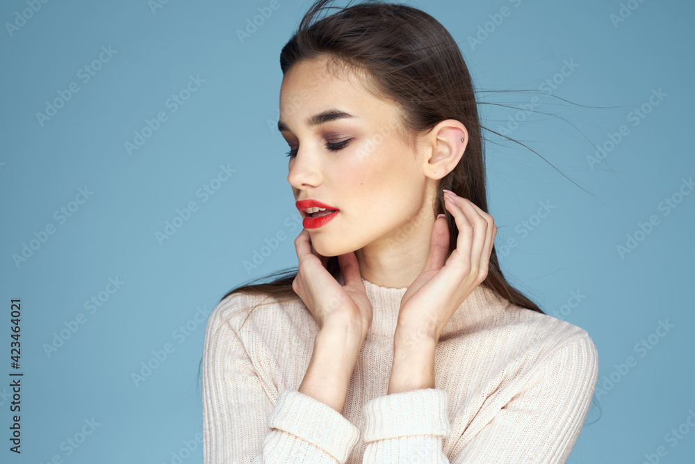 Pretty woman red lips white jacket attractive look close-up blue background Pretty woman red lips white jacket attractive look close-up blue background