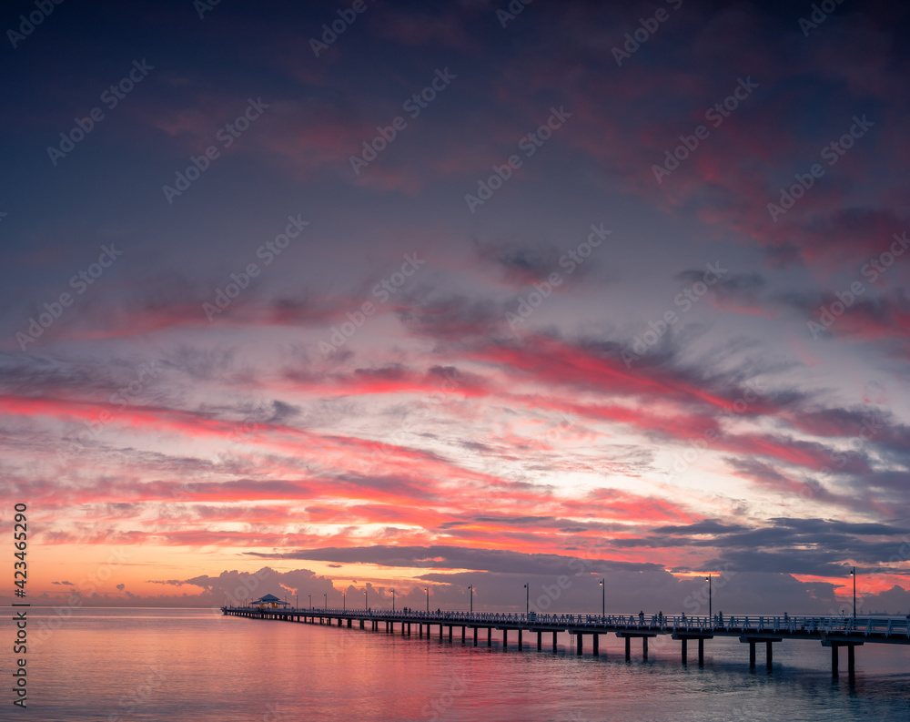 Beautiful Seaside Sunrise with Dramatic Sky and Pier Beautiful Seaside Sunrise with Dramatic Sky and Pier