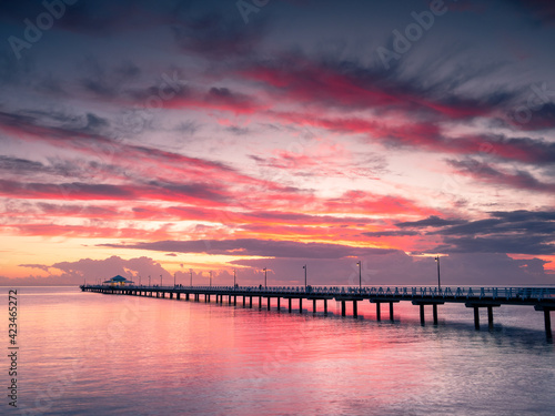 Beautiful Seaside Sunrise with Dramatic Sky and Pier