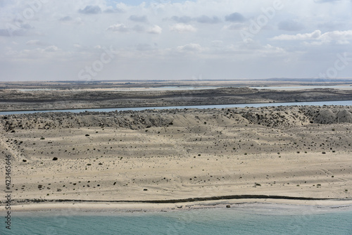 Landscape of Suez Canal, view from transiting cargo ship.