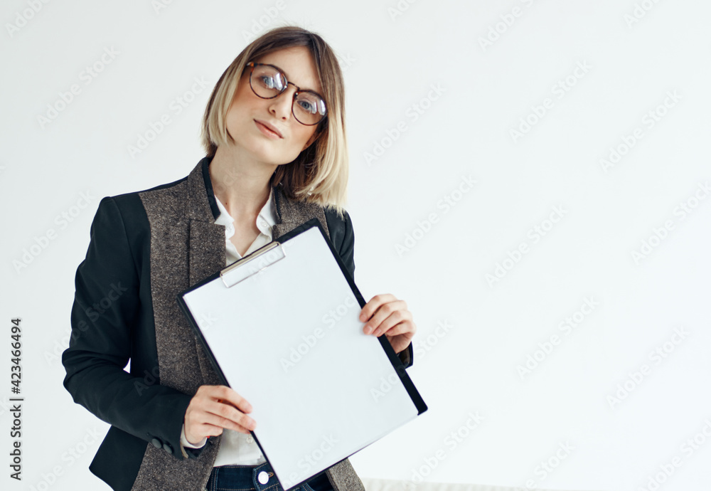 a woman in a formal suit holds a white sheet of paper in her hands Copy Space a woman in a formal suit holds a white sheet of paper in her hands Copy Space