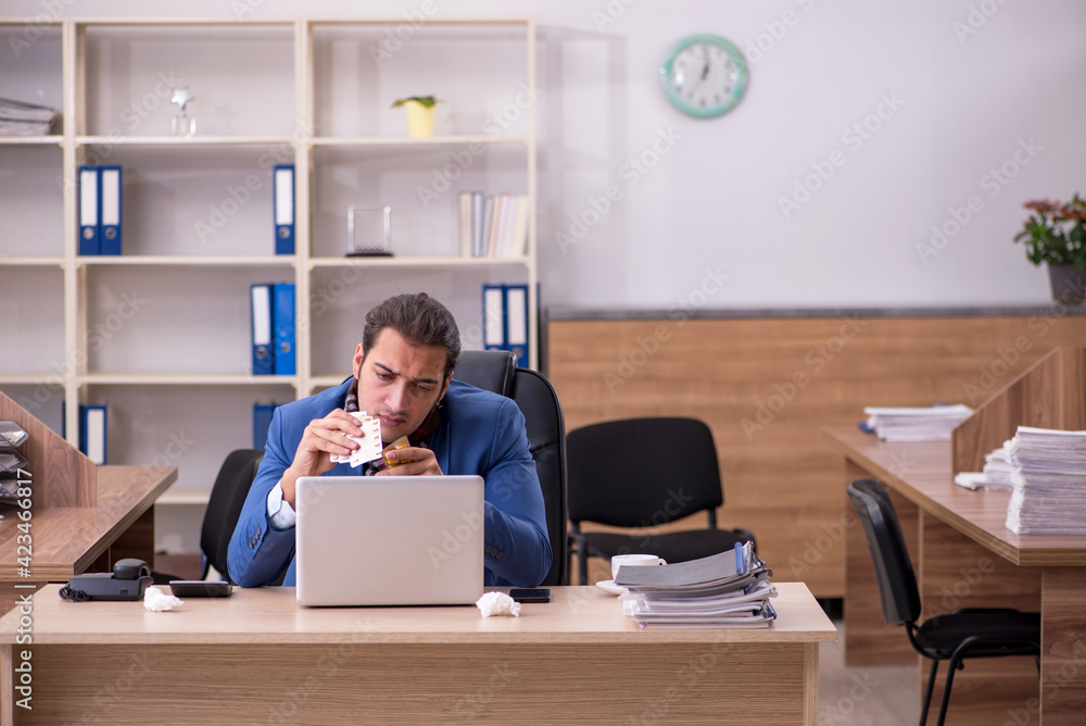 Young sick businessman employee suffering at workplace Young sick businessman employee suffering at workplace