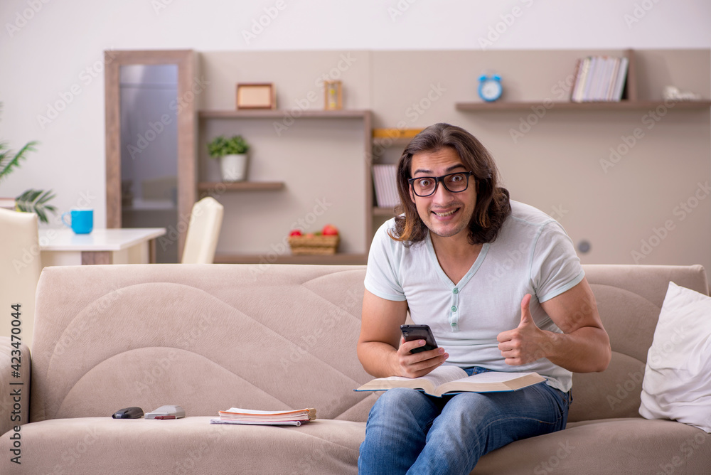 Young male student preparing for exams at home Young male student preparing for exams at home