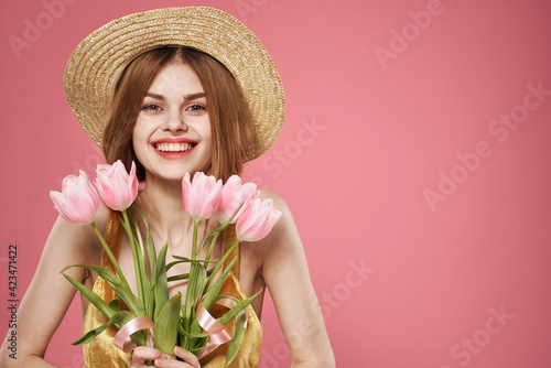 Pretty woman in dress and bouquet of flowers holiday womens day pink background © SHOTPRIME STUDIO