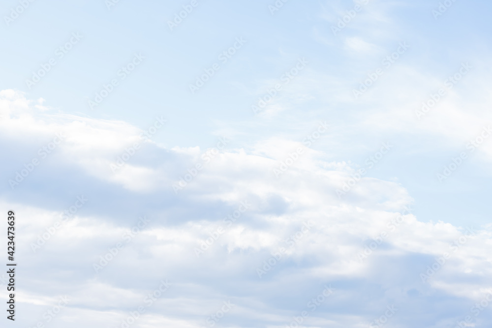 Natural background with light blue spindrift clouds. Abstract backdrop