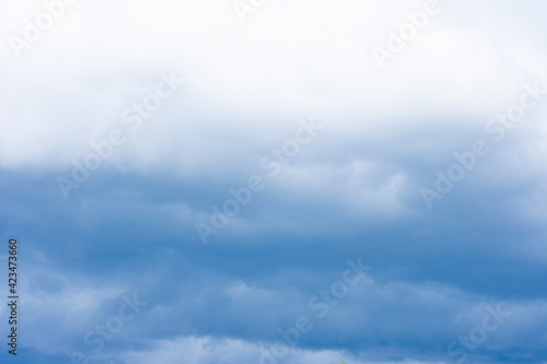 Fototapeta Naklejka Na Ścianę i Meble -  Cumulus clouds, dramatic dark blue summer sky of bad weather, thunderstorm beginning of heavy rain at autumn