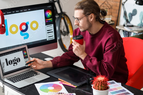 Young male designer working...