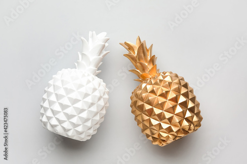 Stylish pineapples on grey background