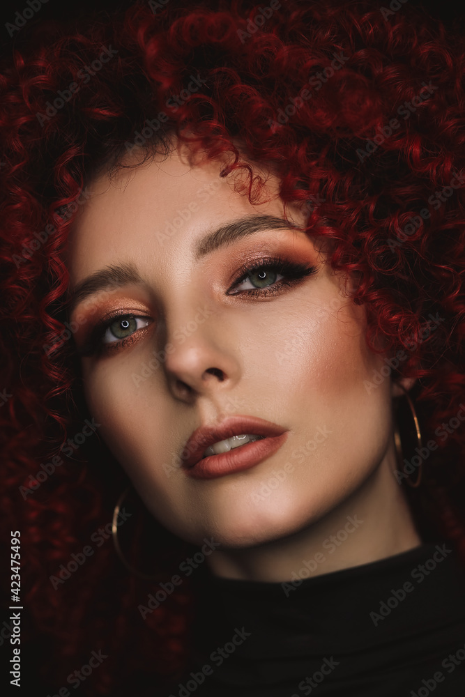 White European girl with afro curls, beautiful casual makeup. Large portrait of a girl with red hair White European girl with afro curls, beautiful casual makeup. Large portrait of a girl with red hair