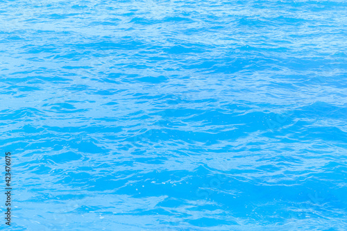 Fototapeta Naklejka Na Ścianę i Meble -  Abstract photo of surface motion water of sea or ocean with beautiful sky blue light tone.