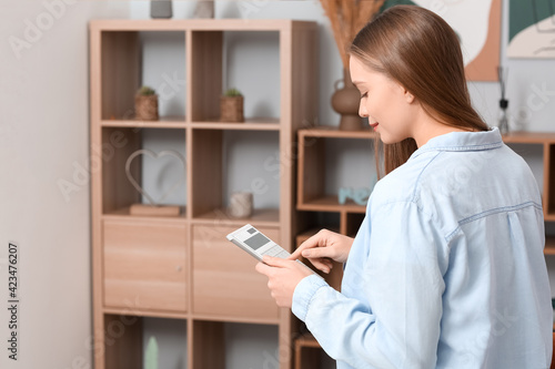 Young woman with calculator...