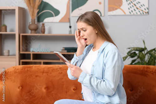 Shocked woman with calculat...