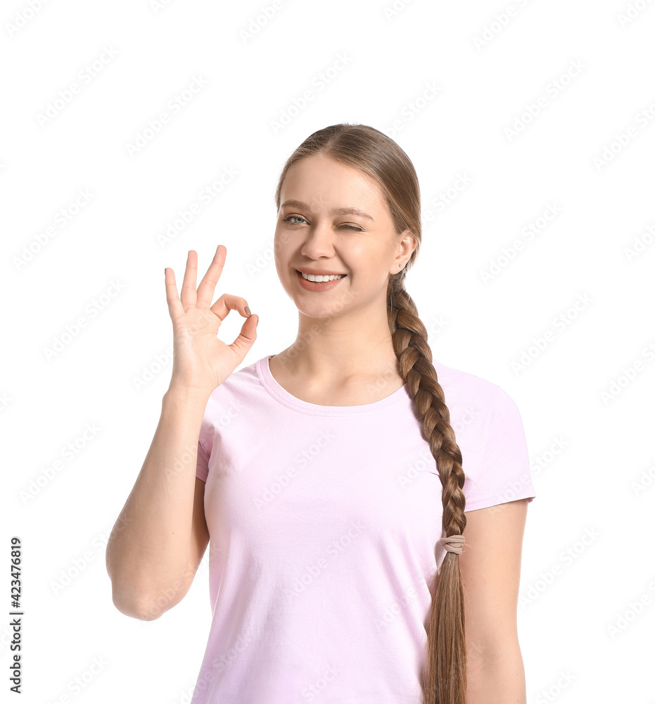 Beautiful smiling young woman showing OK on white background Beautiful smiling young woman showing OK on white background
