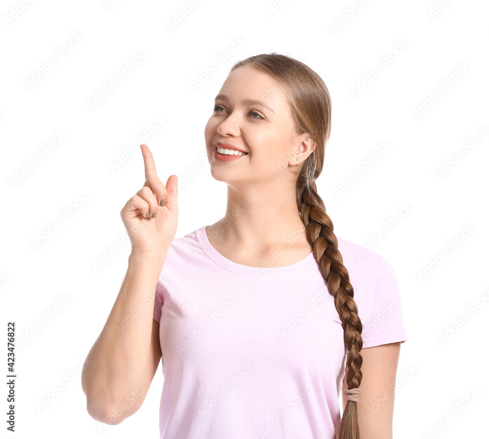 Beautiful smiling young woman pointing at something on white background Beautiful smiling young woman pointing at something on white background