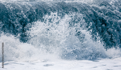 Splashing big waves on the seashore. © schankz
