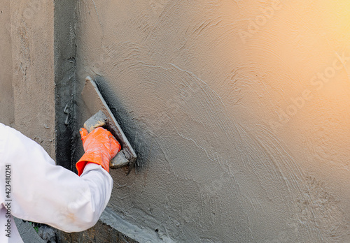 worker using a level cement on the wall