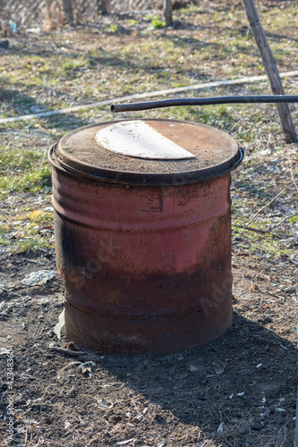 a wood oven made of an old oil barrel