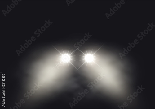 Car headlights in foggy atmosphere photo