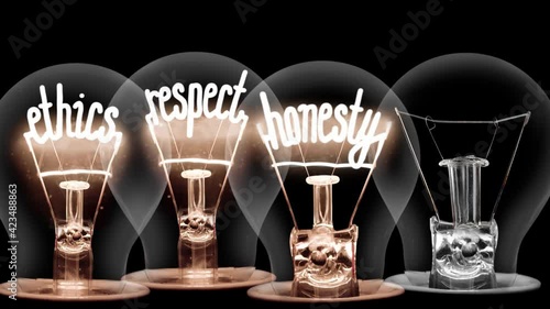 Light bulbs going from dark to light with Ethics, Honesty, Respect and Integrity fiber text on black background. High quality 4k video.