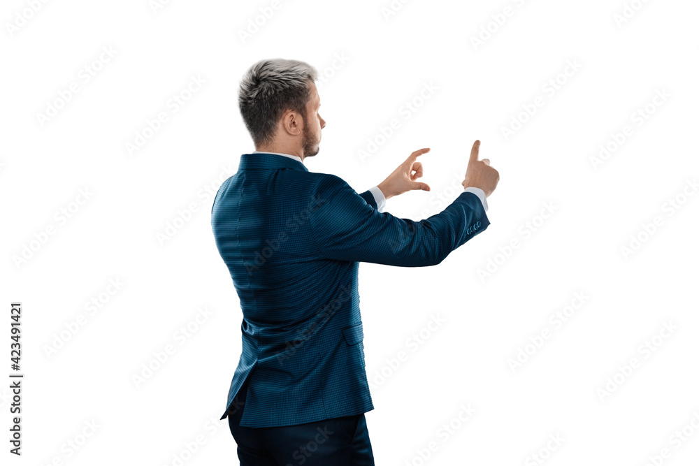 A man, a businessman in a business suit is isolated on a white background, points at something with his finger. A man, a businessman in a business suit is isolated on a white background, points at something with his finger.