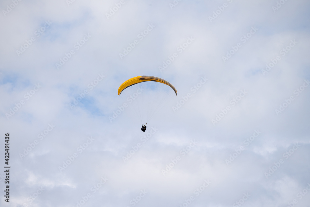 Paraglider flying like a bird in blue cloudy sky. Paraglider flying like a bird in blue cloudy sky.