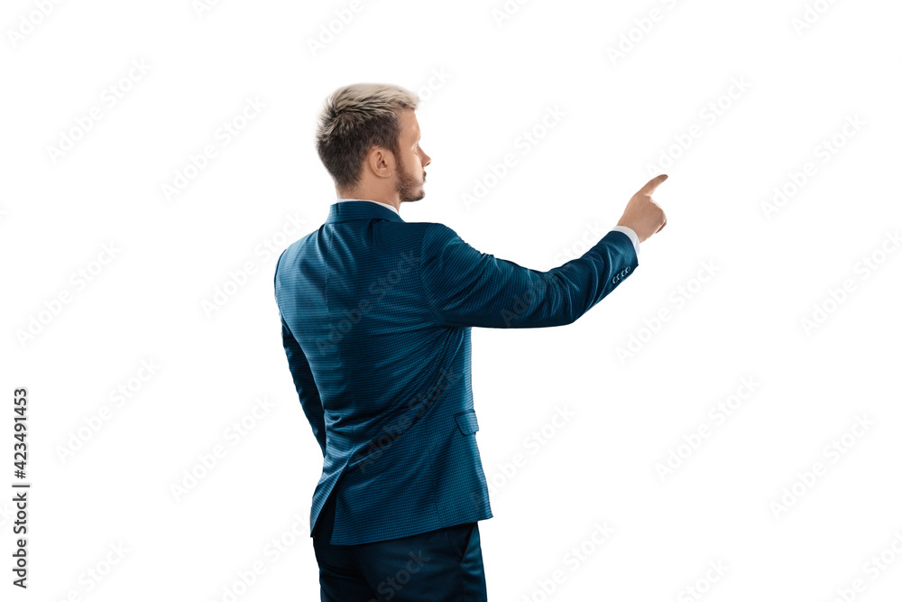 A man, a businessman in a business suit is isolated on a white background, points at something with his finger. A man, a businessman in a business suit is isolated on a white background, points at something with his finger.