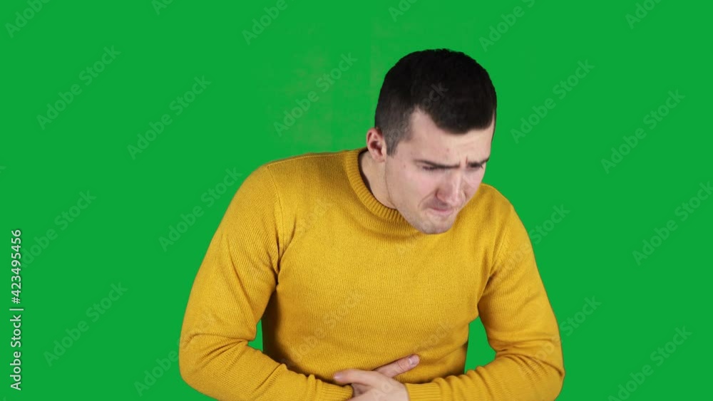 a man has a pain in his left side on a green screen a man has a pain in his left side on a green screen